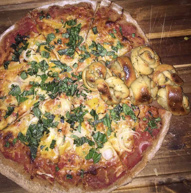 Homemade pizza topped with greens